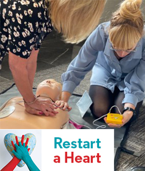 Optical Express employees during CPR training with Restart a Heart Logo