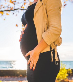 pregnant woman cradling her bump